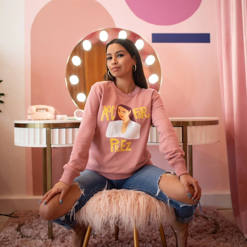 Model is wearing AOC for Prez unisex pink GRL Collective sweatshirt. 100% cotton and pre-shrunk. Model is wearing XS. Sizes are XS-2XL