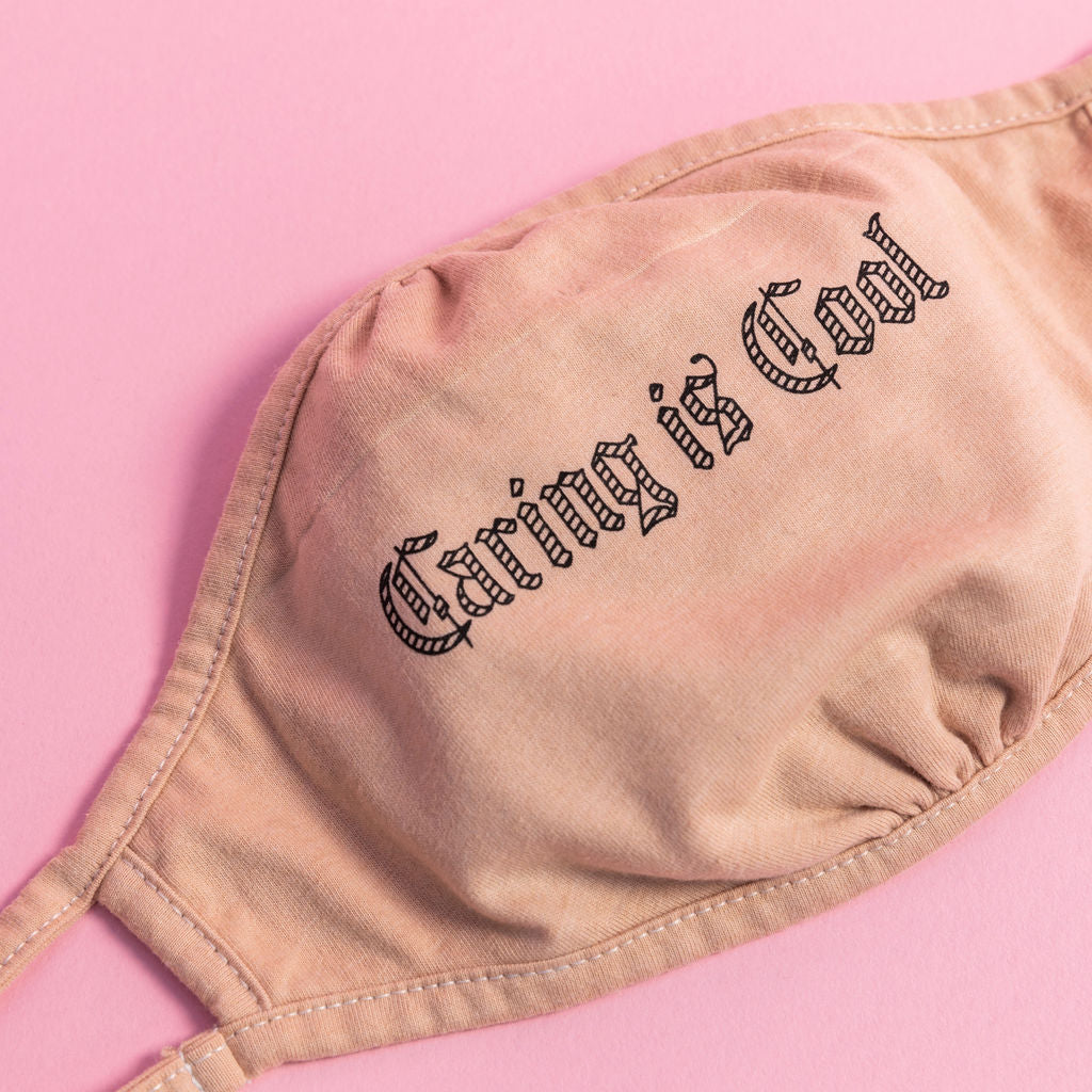 'Caring Is Cool' printed on 100% Breathable reusable unisex mask. Made from approx, 1 recycled water bottle, recycled polyester and cotton. 7 inches wide x 4.5 inches in length. 